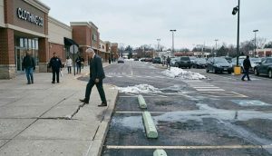 A judge's gavel resting on a stack of legal documents and a house model.