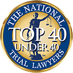 Circular badge featuring "The National Trial Lawyers Top 40 Under 40" text and a graphic of Lady Justice holding scales in the center, representing recognition of Our Attorneys NYC for excellence.