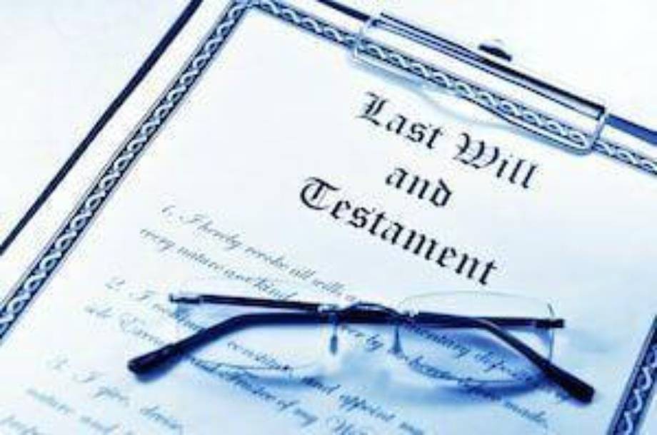 Close-up of a Last Will and Testament document with eyeglasses resting on top.
