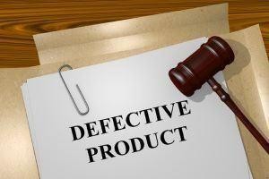 A gavel rests on a stack of papers labeled "Defective Product," symbolizing legal action and raising the question: What Are My Options if I Am Injured By a Defective Product?.